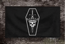 a black flag with a skull in a coffin and a sword .