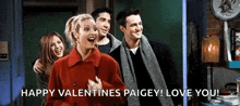 a group of people standing next to each other with the words " happy valentines paigey ! love you ! "