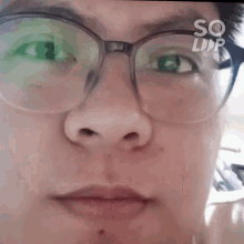a close up of a person 's face with glasses and the word so on the bottom left