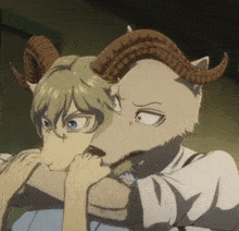 a goat with horns is biting a man 's hand