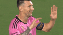 a man in a pink shirt with the name chellyn on the back