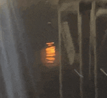 a dark room with a light shining through a window