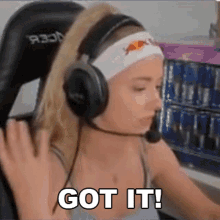 a woman wearing headphones and a headband with a red bull logo on it says got it