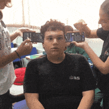 a boy wearing a black shirt that says ' aoc ' on it