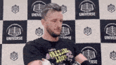 a man wearing a black shirt that says wrestling loop