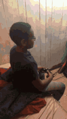 a man sitting on a bed playing a video game with a controller