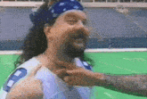 a man with a beard wearing a number 8 jersey