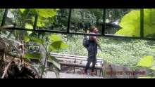 a person walking in a park with a sign that says coyotestyle pro on it