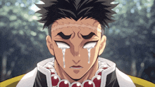 a close up of a man 's face with tears running down his eyes