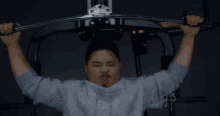 a man is using a machine with chinese writing on the side