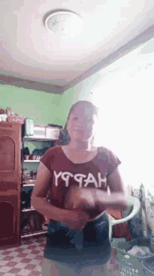 a woman wearing a shirt that says yttah is dancing