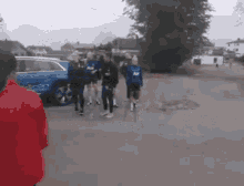 a group of people standing in front of an audi car