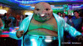 a fat man in a blue jacket and silver pants is dancing