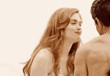 a man and a woman are kissing each other on the cheek .