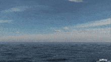 a balloon with a letter c on it is floating in the ocean