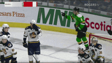a hockey game is being played in front of a banner for mnr scotia