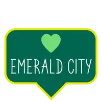a green sign that says emerald city with a heart on it