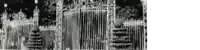 a black and white photo of a gate with a fence in the background .