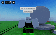 a person in a verified shirt is standing in front of a large rock