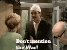 a man with a bandage on his head is talking to a woman while another man looks on ..