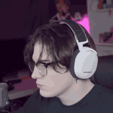 a person wearing a pair of headphones with the word steelseries on it
