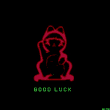 a yellow statue of a cat with the words good luck written below it