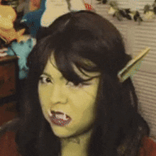 a woman is wearing a wig and making a funny face while looking at the camera .