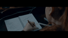 a person is writing in a notebook with the word todd written on it