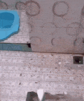 a green bucket with a handle is sitting on top of a bathtub .