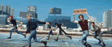 a group of people holding a sign that says boynextdoor