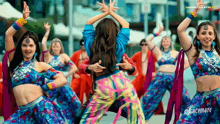a group of women are dancing in front of a sign that says nightvmate