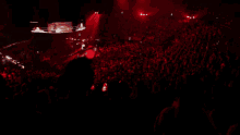 a woman is singing into a microphone on a stage
