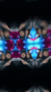 a group of people are posing for a picture in front of a colorful background