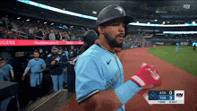 a blue jays player walks off the field