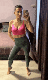 a woman taking a selfie in front of a mirror with a phone that says ' s ' on it