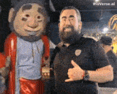 a man with a beard giving a thumbs up next to a cartoon character