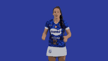 a woman wearing a blue itambé minas number 12 jersey