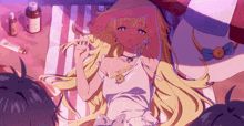 a girl in a white dress is laying on a beach towel