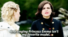 two women are standing next to each other and one of them is singing princess emma is n't my favorite model .
