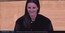 a woman is smiling in front of a program alert