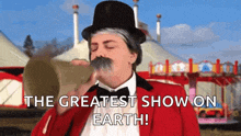 a man in a top hat is blowing a trumpet with the words the greatest show on earth written below him