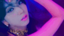 a close up of a woman 's face with pink lipstick and a necklace .