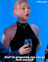 a woman in a black top is holding a glass of wine and says " and i 'm proposing you can go fuck yourself "