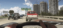 a ford truck is driving down a highway next to a sign that says ' i-280 ' on it