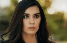 a close up of a woman 's face with a blurred background .