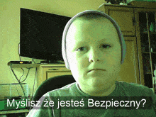 a boy wearing a beanie and a t-shirt is asking if he is safe