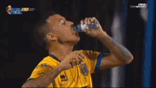 a soccer player wearing a yellow shirt with the number 11 on it