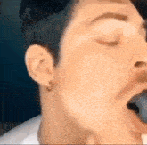 a close up of a person 's face with their eyes closed and their mouth open .