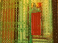 a brick wall with a red door and a shadow of a person