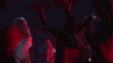 a crowd at a concert with their hands up